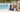 Medex cosmetics next to hand bag by a pool.