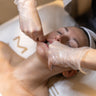 Person receiving a sculpting facial massage treatment.